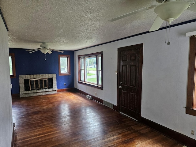 4690 Hubbell Ave, Des Moines, IA 50317 - unfurnished living room featuring a ceiling fan, a textured ceiling, wood-type flooring, and a fireplace