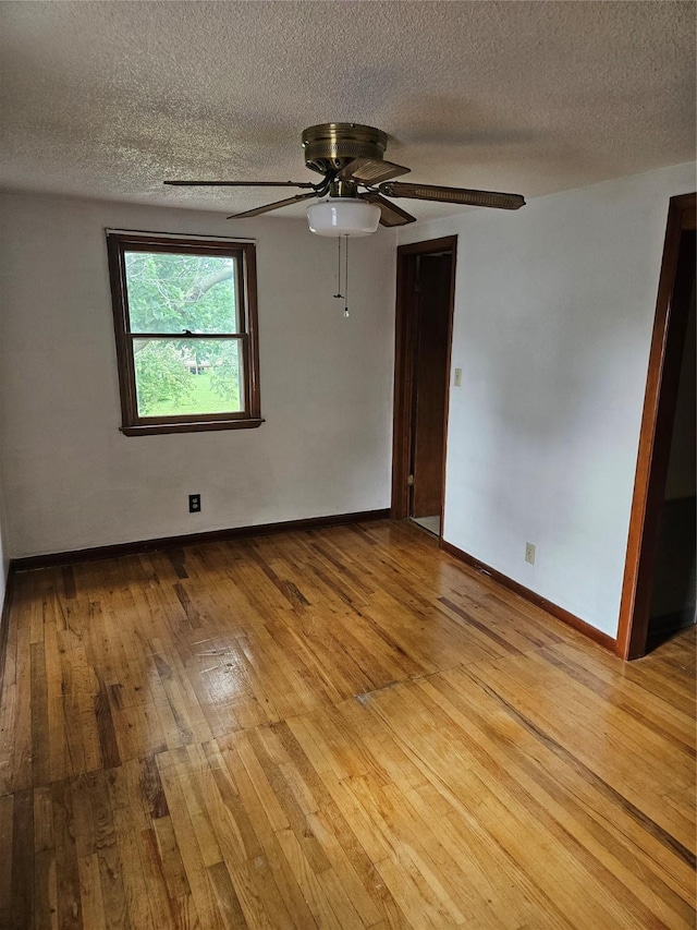 4690 Hubbell Ave, Des Moines, IA 50317 - unfurnished room with hardwood / wood-style flooring, a textured ceiling, and ceiling fan