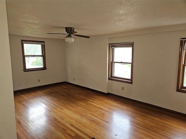 4690 Hubbell Ave, Des Moines, IA 50317 - empty room featuring wood finished floors, a textured ceiling, and a ceiling fan