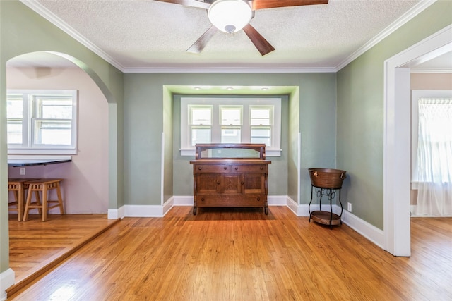 2521 40th St, Des Moines, IA 50310 - entryway with arched walkways, a textured ceiling, wood finished floors, ceiling fan, and ornamental molding