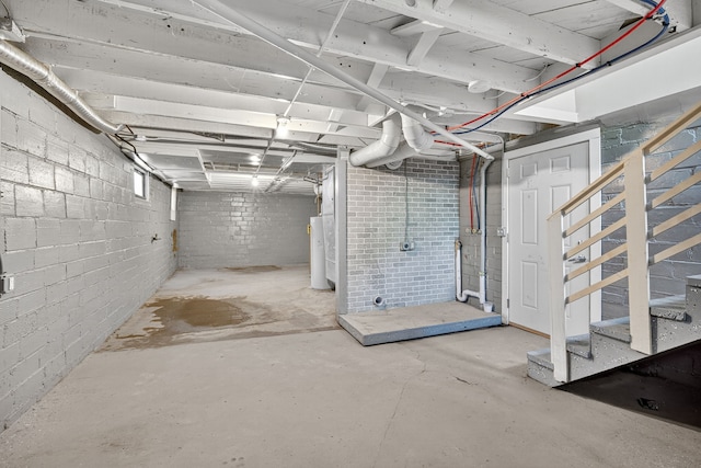 1728 NW Dr, Des Moines, IA 50310 - unfinished basement featuring water heater and stairway