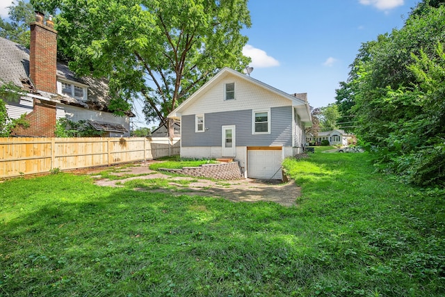 1728 NW Dr, Des Moines, IA 50310 - rear view of house featuring an attached garage