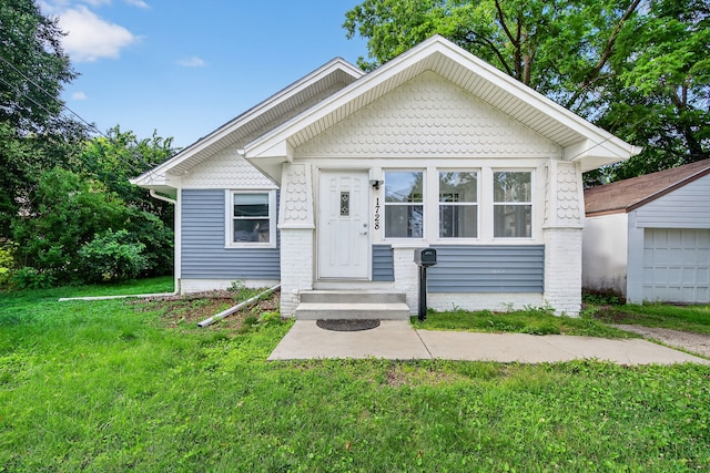 1728 NW Dr, Des Moines, IA 50310 - bungalow-style home featuring a front lawn and a garage