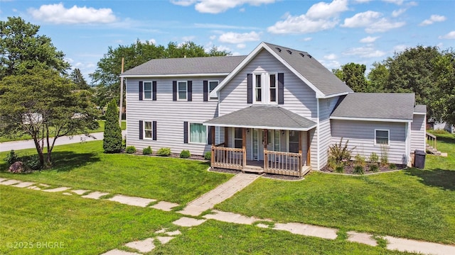 623 N Main St, Stuart, IA 50250 - view of front of home with covered porch, a front yard, and a shingled roof