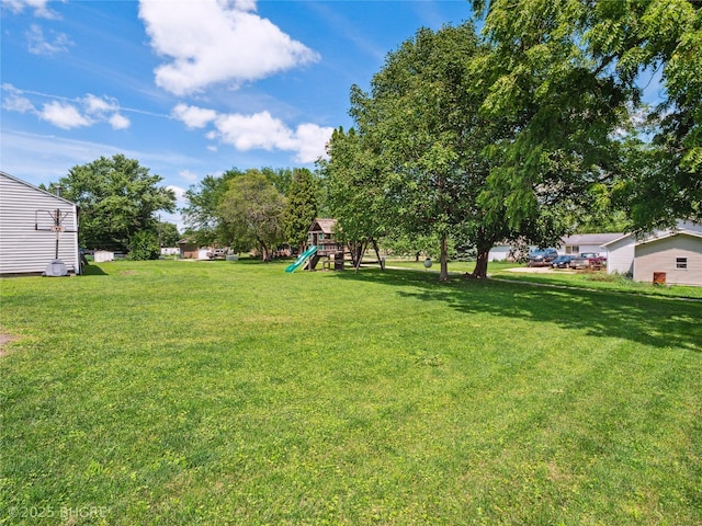 623 N Main St, Stuart, IA 50250 - view of green lawn with a playground