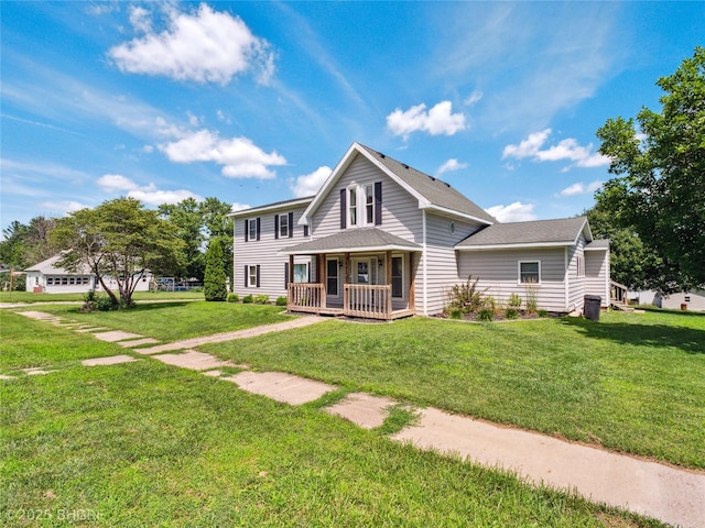 623 N Main St, Stuart, IA 50250 - view of front of property featuring a porch, a front yard, and a shingled roof