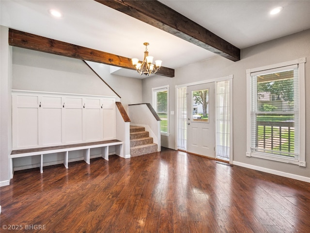 623 N Main St, Stuart, IA 50250 - entryway with stairs, healthy amount of natural light, a chandelier, beam ceiling, and dark wood finished floors