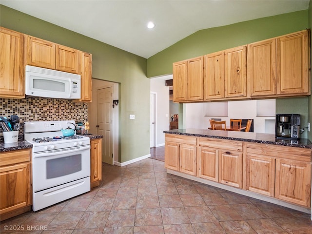 623 N Main St, Stuart, IA 50250 - kitchen featuring white appliances, lofted ceiling, tasteful backsplash, dark stone counters, and light brown cabinetry