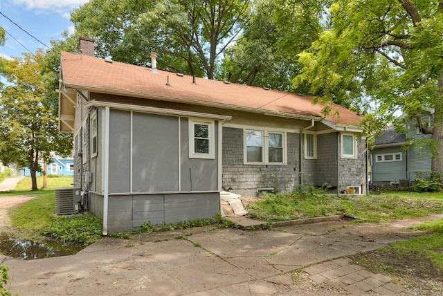 1118 Euclid Ave, Des Moines, IA 50313 - rear view of house featuring a chimney