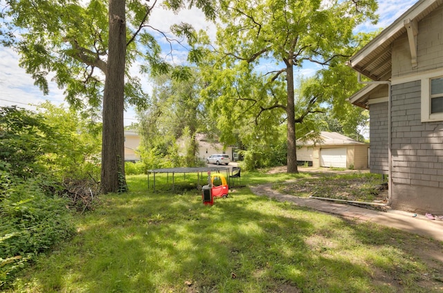 1118 Euclid Ave, Des Moines, IA 50313 - view of grassy yard with a trampoline and a detached garage