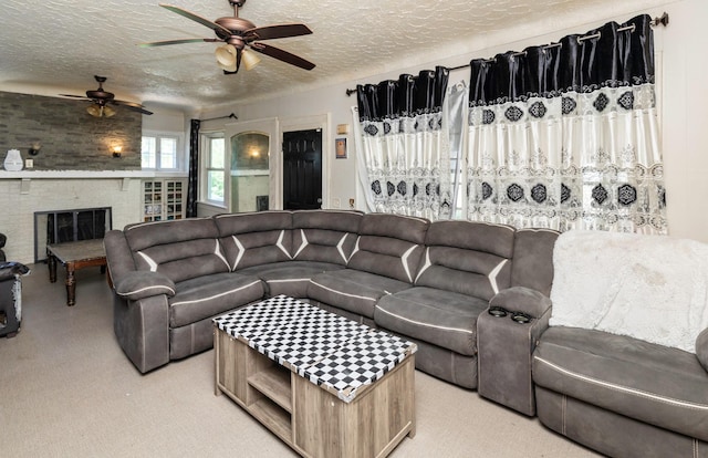 1118 Euclid Ave, Des Moines, IA 50313 - living area featuring ceiling fan, light carpet, a textured ceiling, and a fireplace