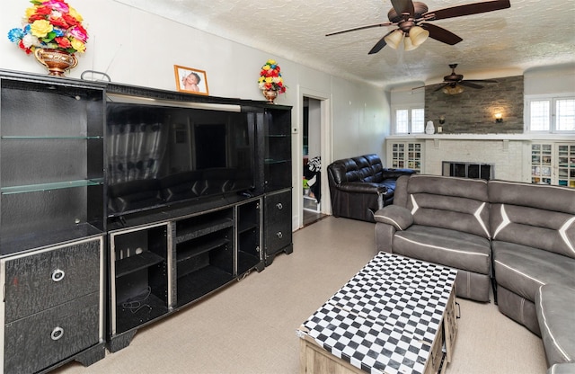 1118 Euclid Ave, Des Moines, IA 50313 - living room featuring ceiling fan, a fireplace, a textured ceiling, and plenty of natural light