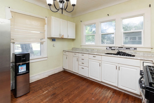 1118 Euclid Ave, Des Moines, IA 50313 - kitchen featuring a chandelier, dark wood-type flooring, range, white cabinets, and light stone countertops