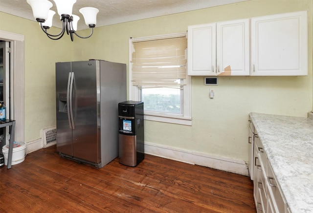 1118 Euclid Ave, Des Moines, IA 50313 - kitchen featuring stainless steel fridge, a chandelier, white cabinetry, and dark wood-type flooring