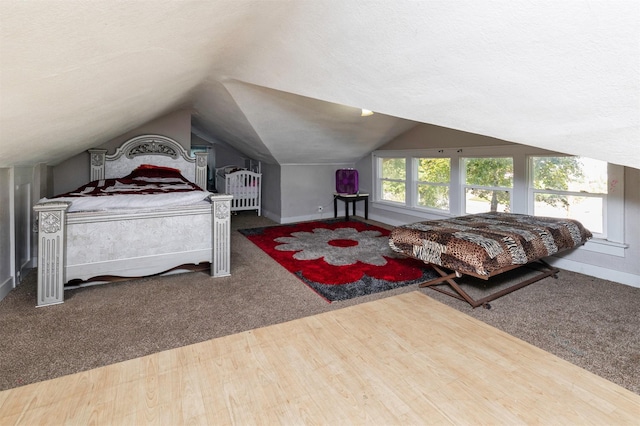 1118 Euclid Ave, Des Moines, IA 50313 - carpeted bedroom with vaulted ceiling and wood finished floors