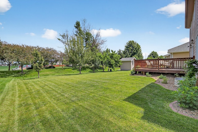4309 129th St, Urbandale, IA 50323 - view of green lawn with a wooden deck and a storage unit