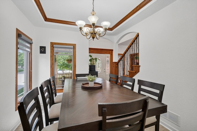 4309 129th St, Urbandale, IA 50323 - dining area featuring a chandelier, stairway, and a raised ceiling