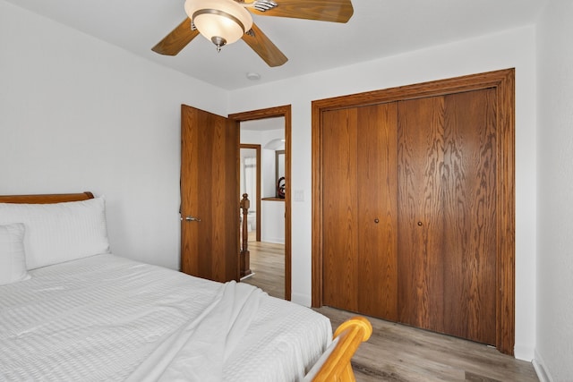4309 129th St, Urbandale, IA 50323 - bedroom with wood finished floors, a closet, and a ceiling fan