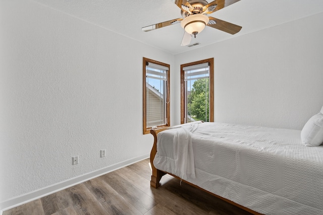 4309 129th St, Urbandale, IA 50323 - bedroom with wood finished floors, a textured wall, and ceiling fan