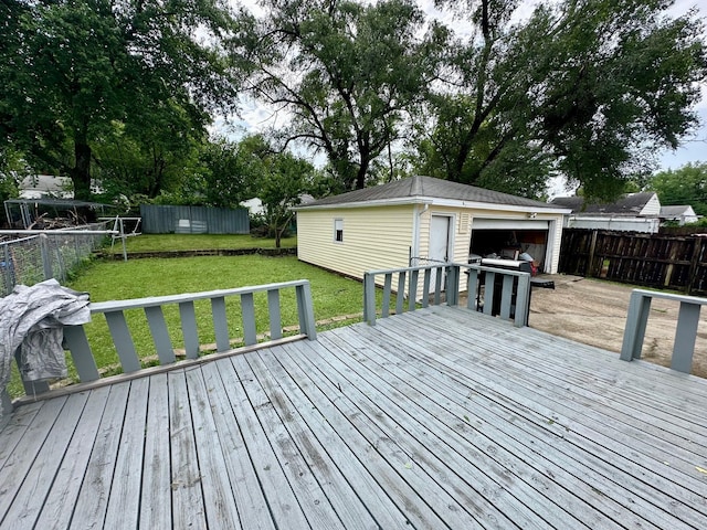 3923 15th St, Des Moines, IA 50313 - wooden deck featuring a fenced backyard, an outdoor structure, and a detached garage