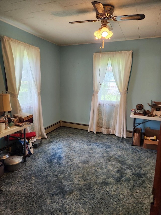 503 Main St, Harvey, IA 50119 - dining room featuring ceiling fan, carpet floors, and a baseboard heating unit