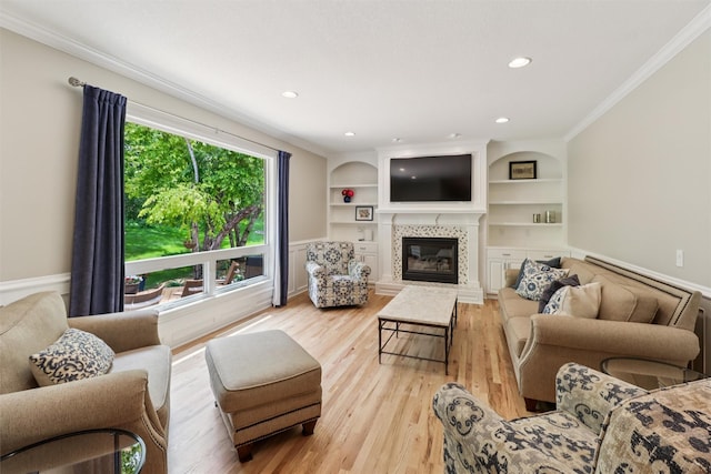 7016 Harbour Dr, Johnston, IA 50131 - living room with crown molding, a fireplace, light wood-style floors, built in shelves, and recessed lighting