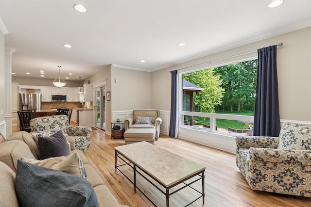 7016 Harbour Dr, Johnston, IA 50131 - living room with ornamental molding, light wood-style floors, recessed lighting, and wainscoting