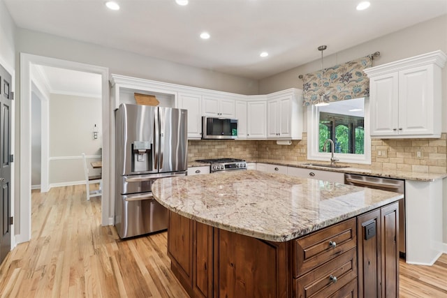 7016 Harbour Dr, Johnston, IA 50131 - kitchen featuring stainless steel appliances, white cabinetry, decorative backsplash, light wood finished floors, and recessed lighting