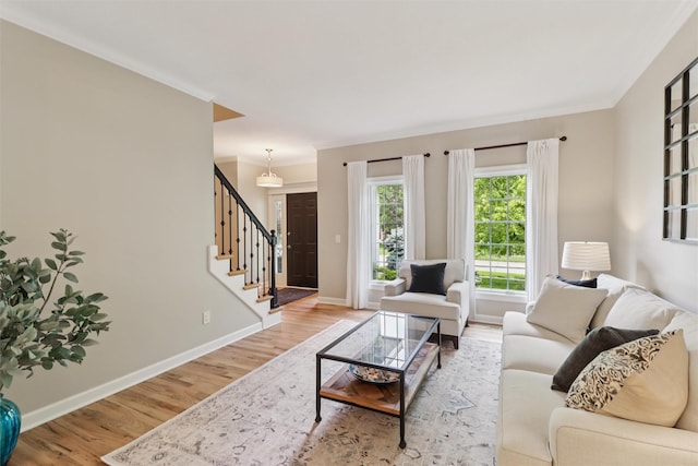 7016 Harbour Dr, Johnston, IA 50131 - living room featuring stairs, wood finished floors, and ornamental molding