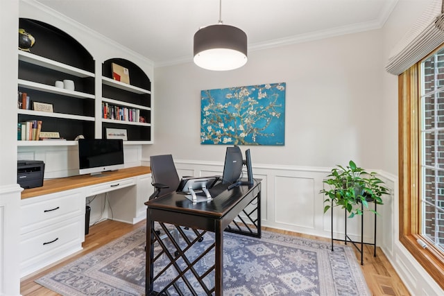 7016 Harbour Dr, Johnston, IA 50131 - home office with built in desk, ornamental molding, light wood-type flooring, and a wainscoted wall