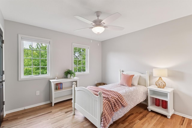 7016 Harbour Dr, Johnston, IA 50131 - bedroom with light wood finished floors and ceiling fan