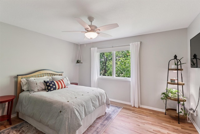 7016 Harbour Dr, Johnston, IA 50131 - bedroom with light wood-style flooring and a ceiling fan
