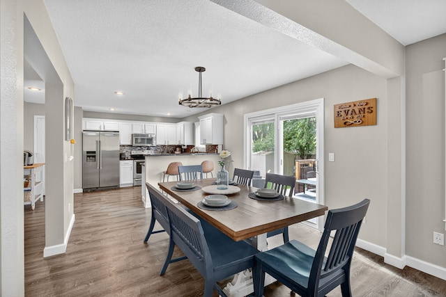 4808 Dewey Pl, Johnston, IA 50131 - dining room with light wood-type flooring, a chandelier, and recessed lighting