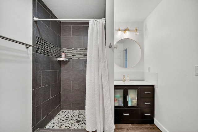 4808 Dewey Pl, Johnston, IA 50131 - full bathroom featuring tiled shower, vanity, and wood finished floors