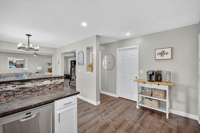 4808 Dewey Pl, Johnston, IA 50131 - kitchen featuring dishwasher, wood finished floors, white cabinetry, a chandelier, and hanging light fixtures