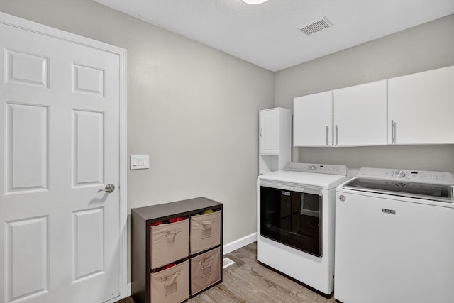 4808 Dewey Pl, Johnston, IA 50131 - laundry area featuring washer and clothes dryer, light wood-style floors, and cabinet space