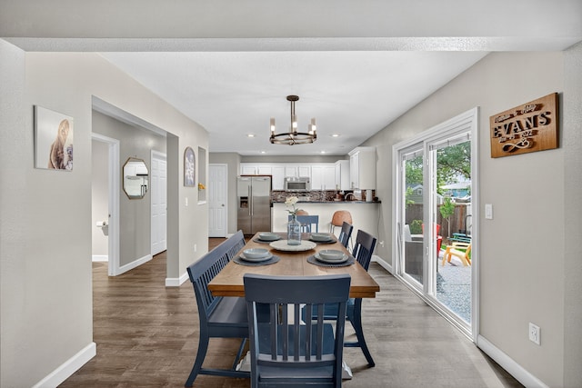 4808 Dewey Pl, Johnston, IA 50131 - dining room with a chandelier, wood finished floors, and recessed lighting