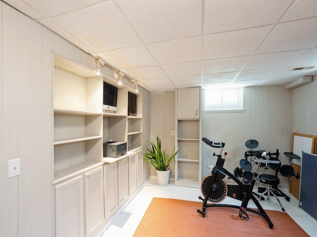 1655 NW Dr, Des Moines, IA 50310 - exercise area with a paneled ceiling, wood walls, and rail lighting