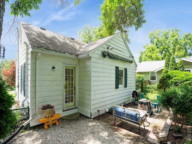 1655 NW Dr, Des Moines, IA 50310 - rear view of house featuring a shingled roof and a patio