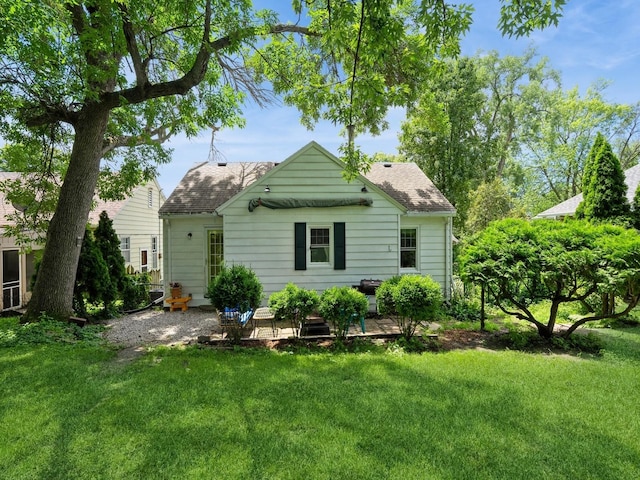 1655 NW Dr, Des Moines, IA 50310 - back of house featuring a lawn and a shingled roof