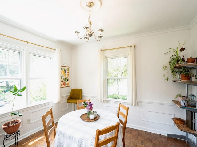 1655 NW Dr, Des Moines, IA 50310 - dining space featuring healthy amount of natural light, a chandelier, crown molding, and a wainscoted wall