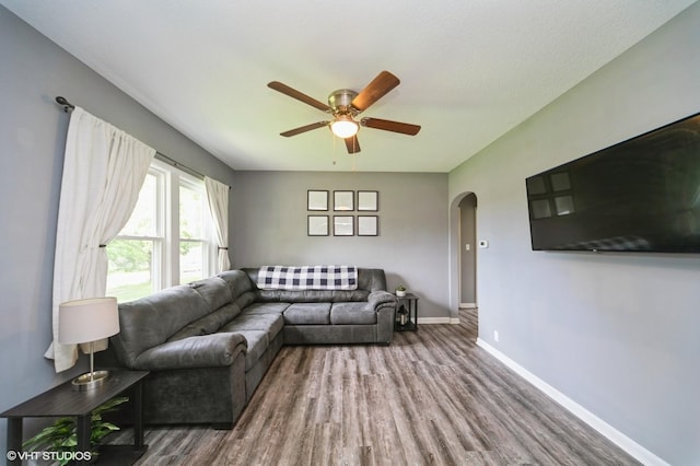 3411 61st St, Des Moines, IA 50322 - living area featuring arched walkways, wood finished floors, and a ceiling fan