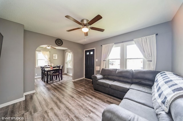 3411 61st St, Des Moines, IA 50322 - living room with arched walkways, a ceiling fan, and wood finished floors