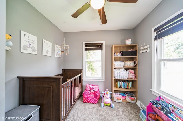 3411 61st St, Des Moines, IA 50322 - carpeted bedroom with a nursery area and ceiling fan