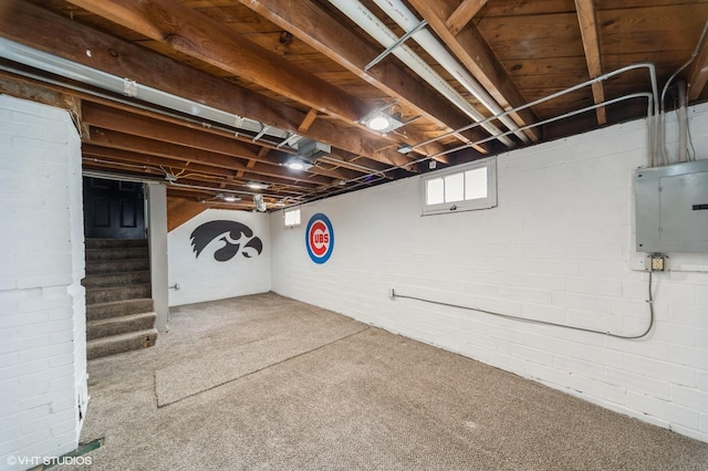 3411 61st St, Des Moines, IA 50322 - below grade area with electric panel, stairway, and carpet flooring