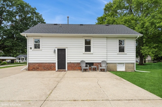 3411 61st St, Des Moines, IA 50322 - rear view of house with a patio, a lawn, and a shingled roof