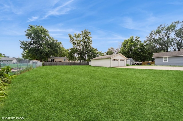 3411 61st St, Des Moines, IA 50322 - view of yard featuring a garage and an outdoor structure