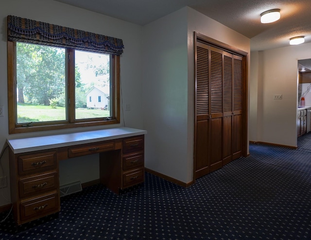 1108 Hillcrest Ct, Chariton, IA 50049 - unfurnished office featuring dark colored carpet and built in desk