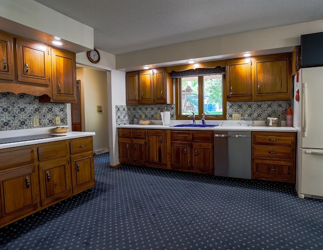 1108 Hillcrest Ct, Chariton, IA 50049 - kitchen with dishwasher, freestanding refrigerator, dark carpet, light countertops, and a textured ceiling
