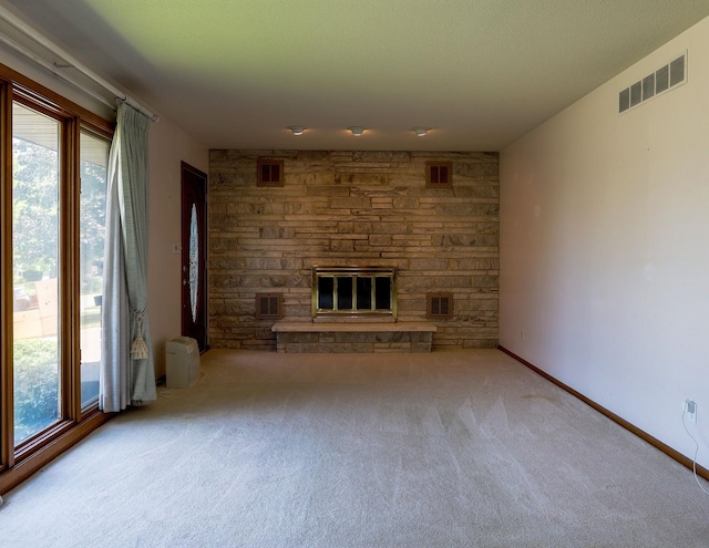 1108 Hillcrest Ct, Chariton, IA 50049 - unfurnished living room with a fireplace, carpet floors, and plenty of natural light